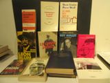 many books that are sitting on a table next to each other