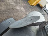 a skateboard that is laying on the ground next to a trash can