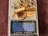 a digital scale with a bunch of gold coins on it