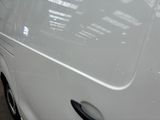 a white van parked in a parking lot with its door open