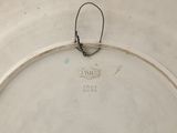 a white plate with a black handle on it