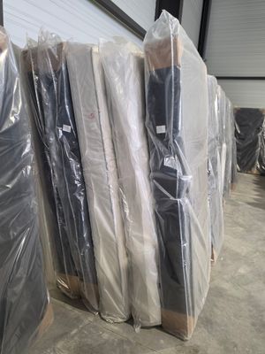 de nombreux matelas emballés dans des sacs en plastique dans un entrepôt