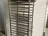 a rack with trays of food on it in a kitchen