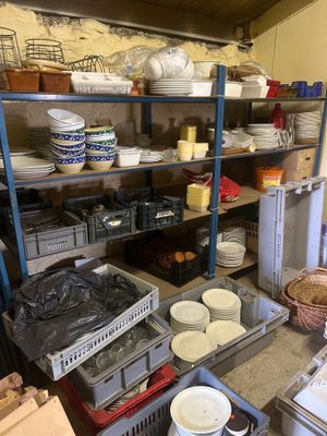 beaucoup d'assiettes et de bols sur les étagères de la cuisine
