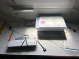 a white printer sitting on top of a table next to a window