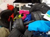a pile of luggage sitting on top of a bed