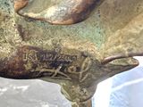 a bronze statue of a horse on a table