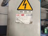 an electric box with a sign on it in a warehouse