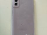 a white cell phone sitting on top of a table