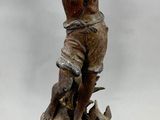 a statue of a boy with a bird on a pedestal