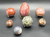 many different types of stones on a black surface