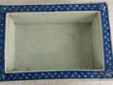 a small blue and white plate with a blue border