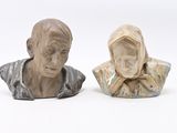 two busturines of a man and a woman sitting next to each other