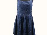 a dress on a mannequin stand with a white background