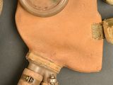 a gas mask and a pair of gloves on a table