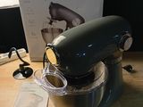 a kitchen aid mixer on a table with a box on the table