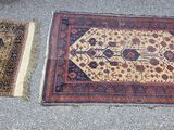 two oriental rugs on the ground next to each other
