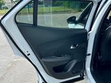 a white car with its door open in a parking lot