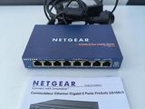 a netgear router and a power supply on a table