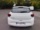a white car parked in a parking lot with trees in the background
