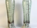 two vases that have been decorated with trees on them