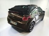 a car that is parked in a room with white flooring