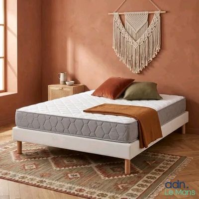 an image of a bedroom with a bed and a rug on the floor