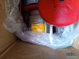 a red blower sitting inside of a cardboard box