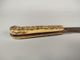 a knife that is on top of a banana