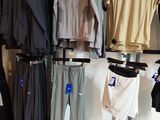 a lot of clothes hanging on a rack in a store