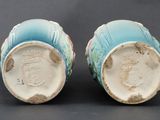pair of blue and white vases sitting on top of a table