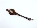 a small wooden spoon with a metal handle on a white surface