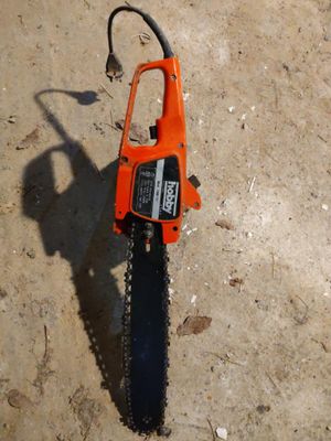 a chainsaw that is laying on the ground