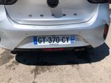 the rear end of a silver car parked in a parking lot
