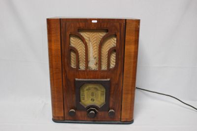 an old radio sitting on a table with a white background