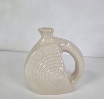 a white vase that has a spiral design on it