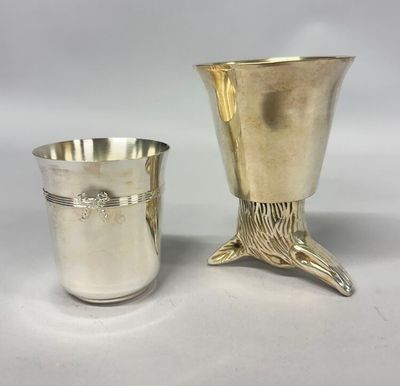 a silver cup and a silver beakle on a white background