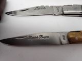 two knives that are sitting next to each other on a table