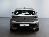 the rear end of a silver car in a white room