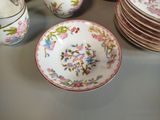 many plates and cups sitting on a table