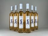 four bottles of wine are lined up on a table