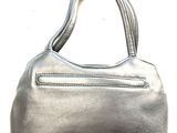 silver leather handbag on a white surface with a white background