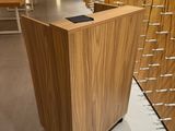 a wooden counter with a phone on it in a room