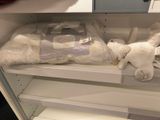 a stuffed animal that is sitting on a shelf in a refrigerator