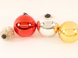 three christmas ornaments on a white surface