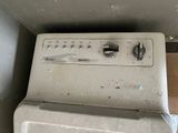 a dirty washer and dryer in a dirty room