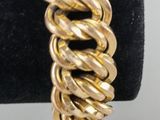 a close up of a gold bracelet on a black ring
