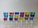 six different colored wine glasses are lined up on a table