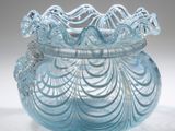 a blue glass vase with a decorative design on it