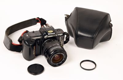 a black camera and a black case on a white surface